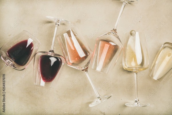 Wunschmotiv: Flat-lay of red, rose and white wine in glasses over grey concrete background, top view