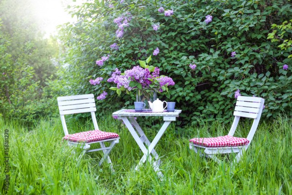 Wunschmotiv: Lilac flowers on table in beautiful garden #158111270